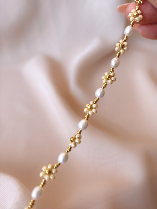 Close up of August Pearl Bracelet featuring premium Japanese seed bead gold daisies and white freshwater pearls.