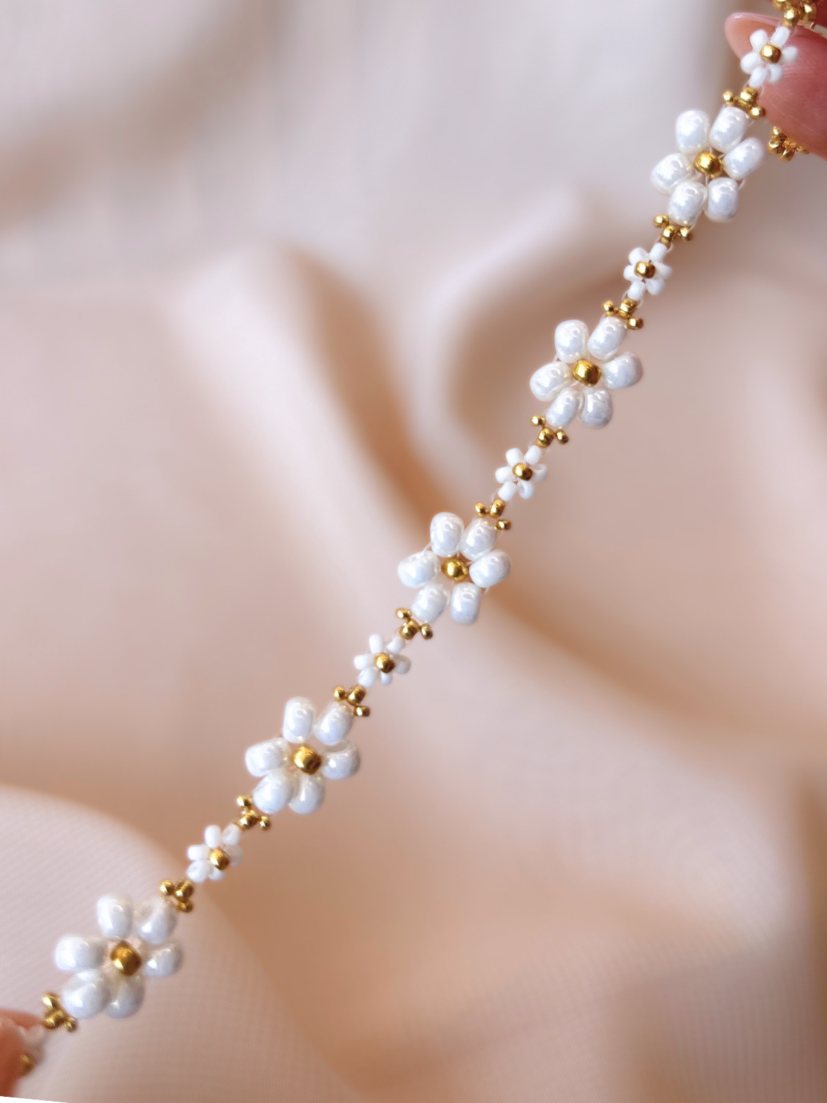 Close up of Dear Daisy Bracelet in Cloud Nine, showcasing premium Japanese seed bead white flowers.