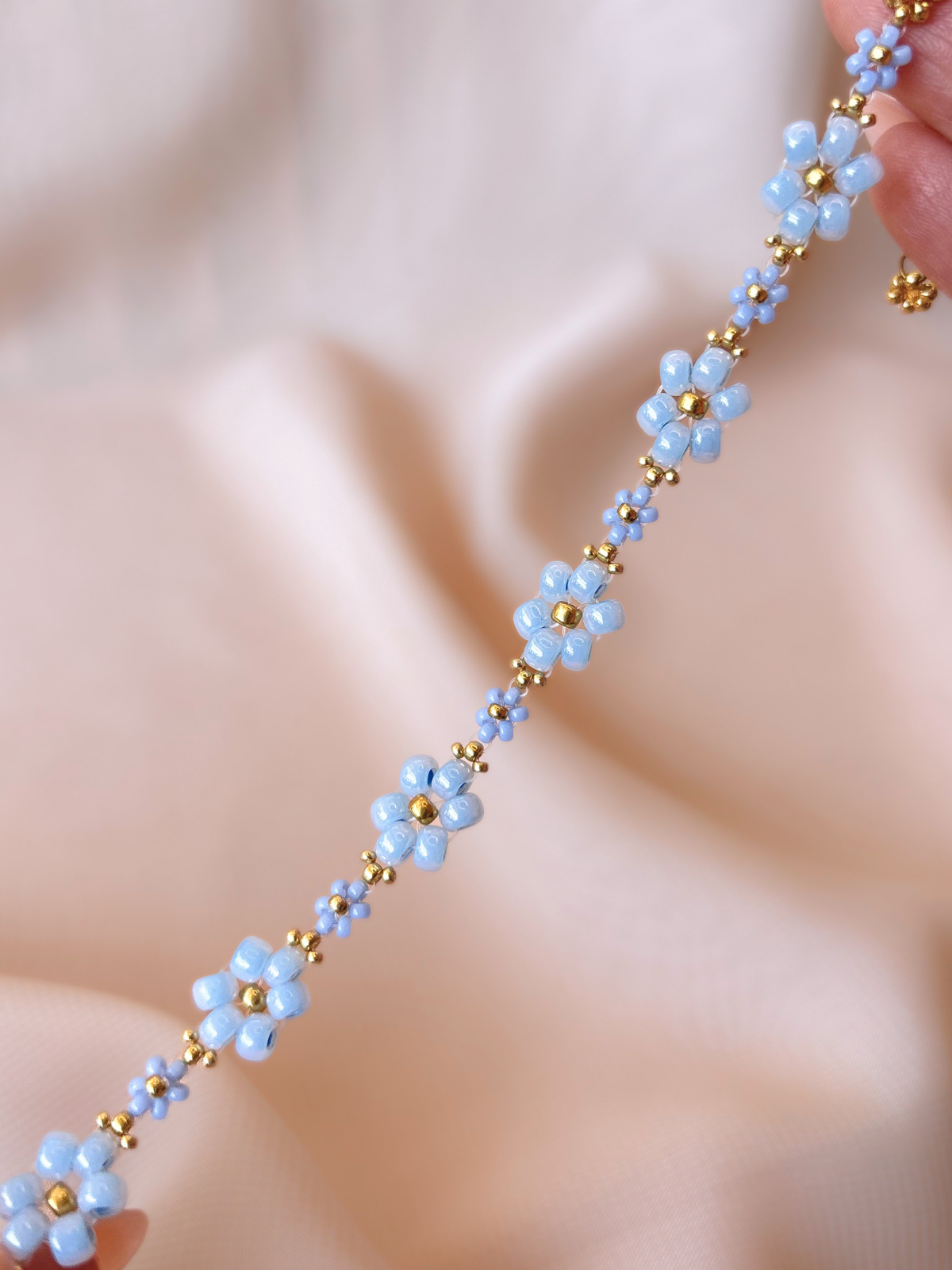 Close up of Dear Daisy Bracelet in Glass Slipper, showcasing premium Japanese seed bead blue flowers.