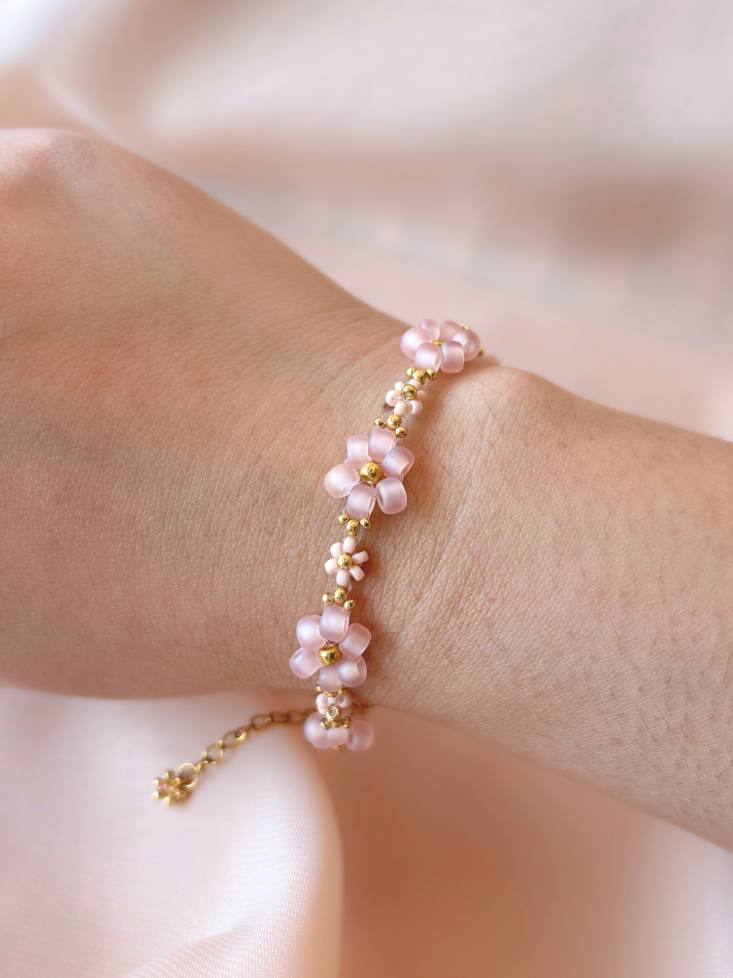 Dear Daisy Bracelet in Slow Dance, featuring pink blush flower beads made of premium Japanese seed beads, shown worn on a wrist.