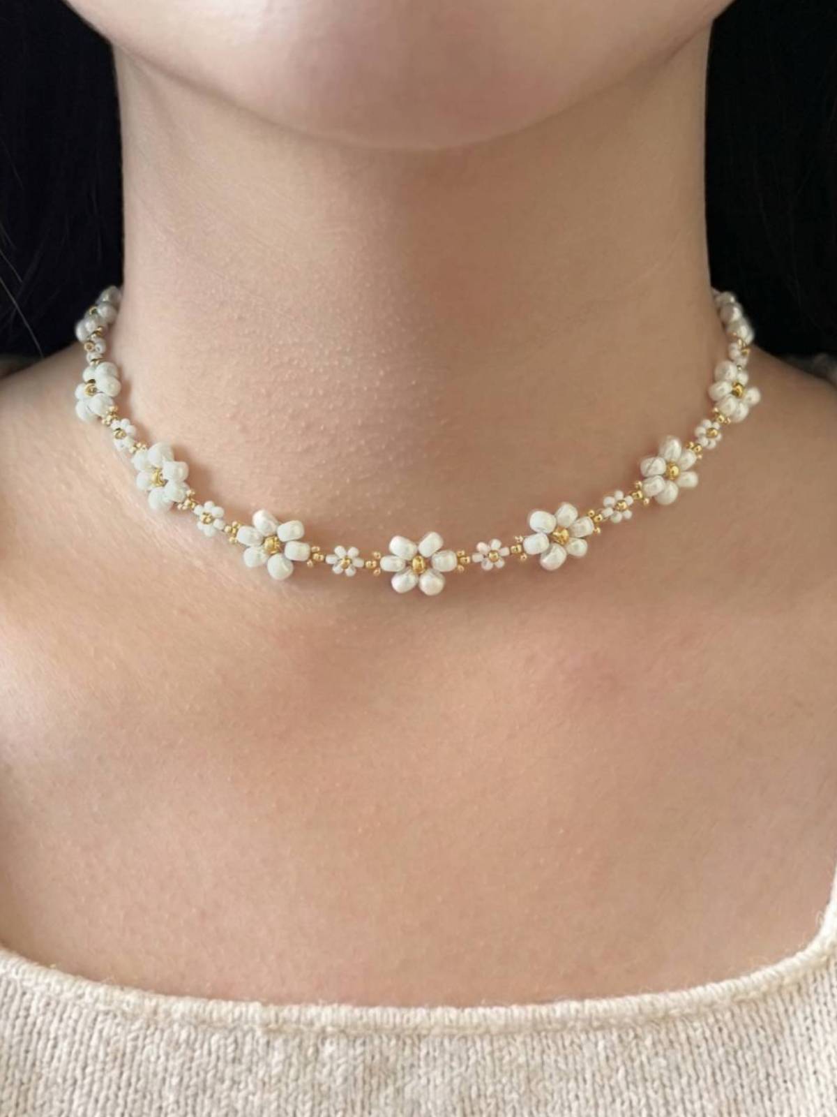 Dear Daisy Choker in Cloud Nine, featuring white flower beads made of premium Japanese seed beads, shown worn on a model's neck.
