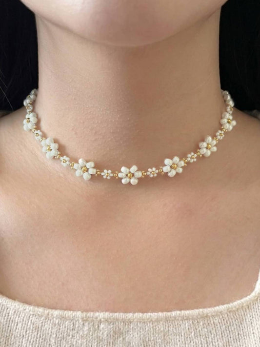 Dear Daisy Choker in Cloud Nine, featuring white flower beads made of premium Japanese seed beads, shown worn on a model's neck.