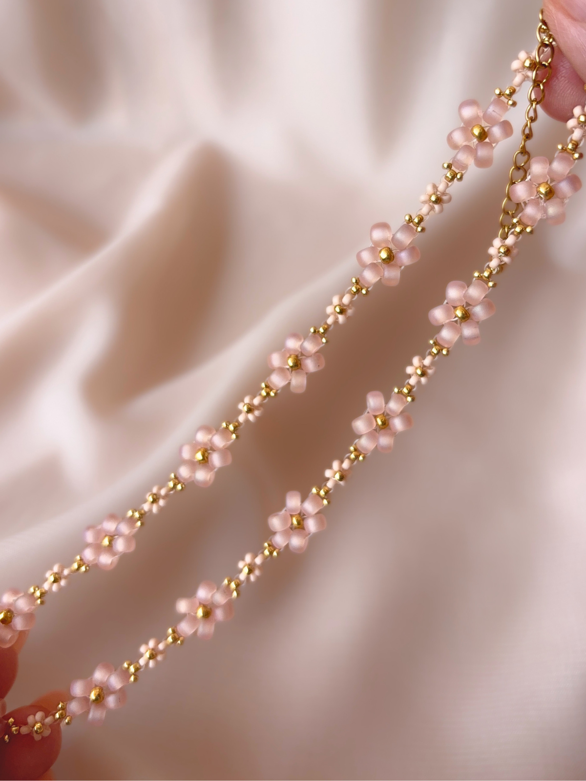 Close up of Dear Daisy Choker in Slow Dance, showcasing pink blush flower designs made of premium Japanese seed beads.