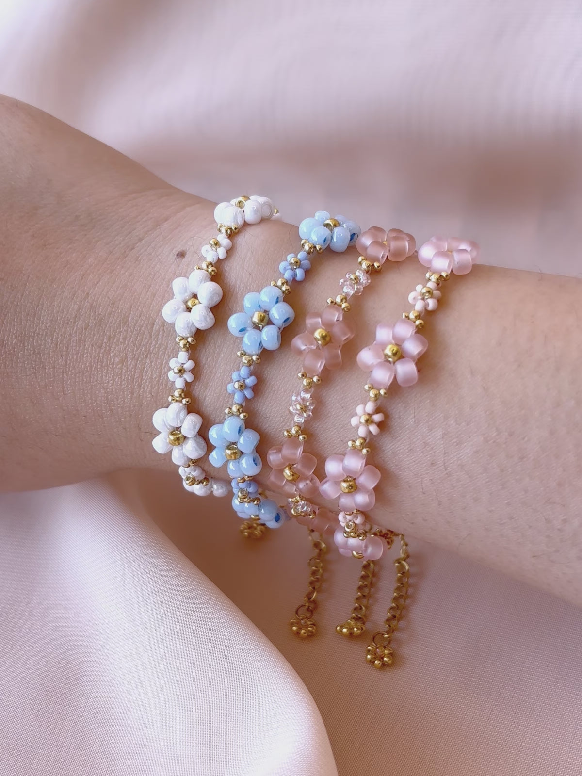 A video showcasing each color of the Dear Daisy flower bracelet collection worn on a wrist, highlighting the premium Japanese seed beads and their unique sparkle.