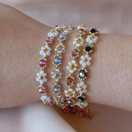 A video showcasing each color of the Wildflower Coquette bracelet collection worn on a wrist, highlighting their unique sparkle under the light.