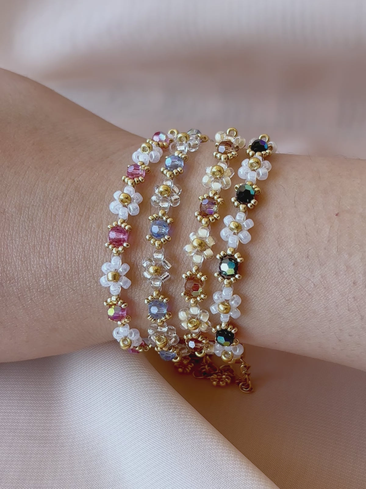 A video showcasing each color of the Wildflower Coquette bracelet collection worn on a wrist, highlighting their unique sparkle under the light.