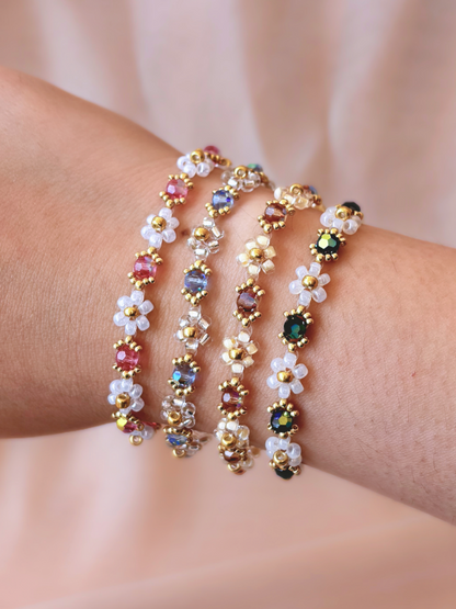 A stack of four Wildflower Coquette flower bracelets in all available colorways, showcasing the premium Japanese seed beads and sparkling Preciosa crystals on a wrist.