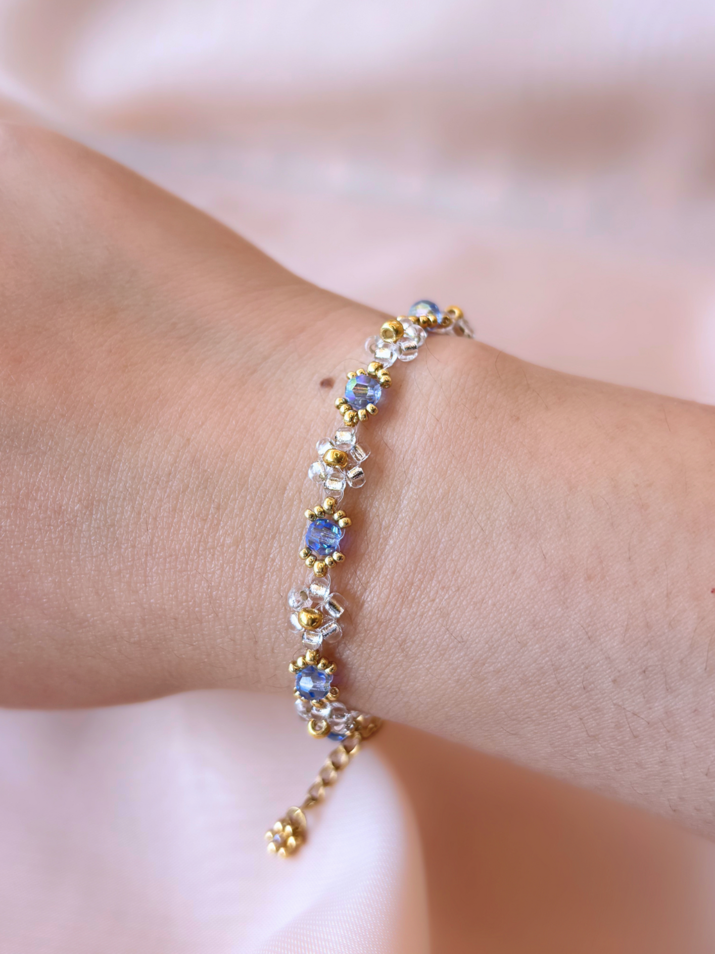 Wildflower Coquette bracelet in Pixie Dust, made of premium Japanese seed bead daisies with blue Preciosa crystal AB centers.