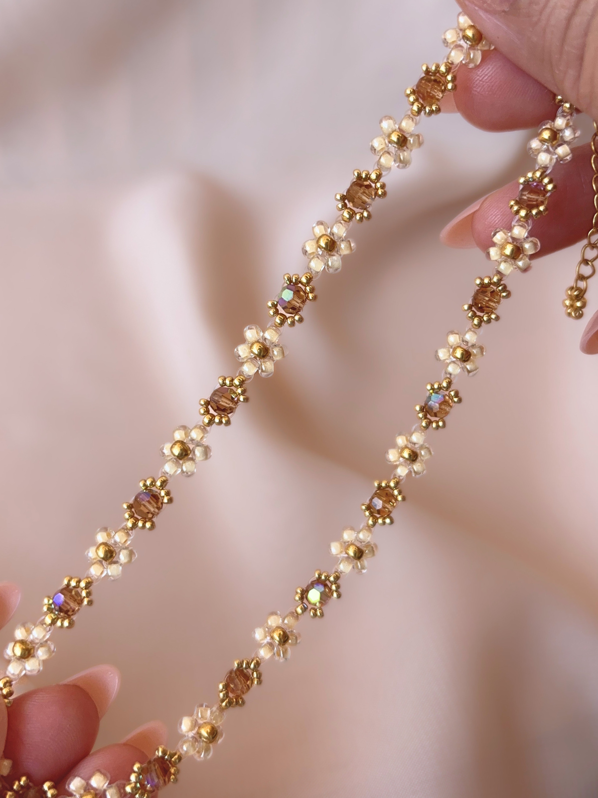 Close up of Wildflower Coquette Choker in Gold Rush, showcasing premium Japanese seed bead daisies and topaz Preciosa crystals.