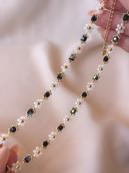 Close up of Wildflower Coquette Choker in Midnight Rain, showcasing premium Japanese seed bead daisies and black Preciosa crystals.