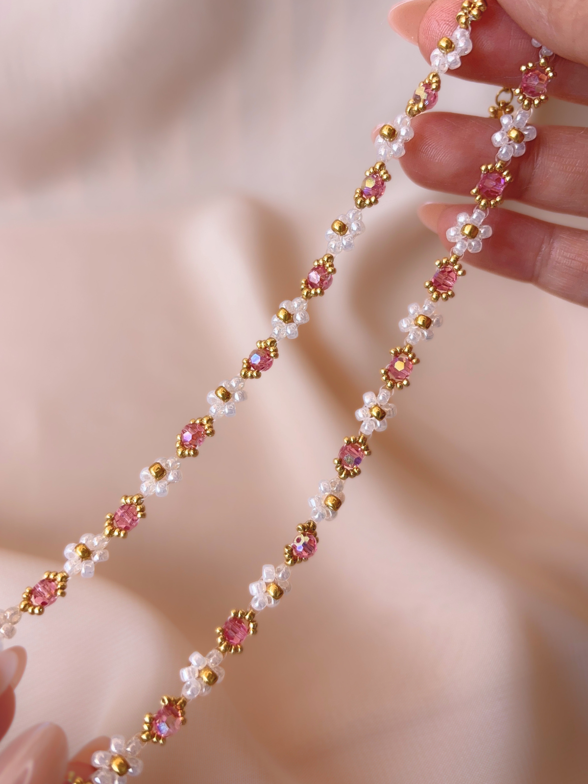 Close up of Wildflower Coquette Choker in Pinky Promise, showcasing premium Japanese seed bead daisies and pink Preciosa crystals.