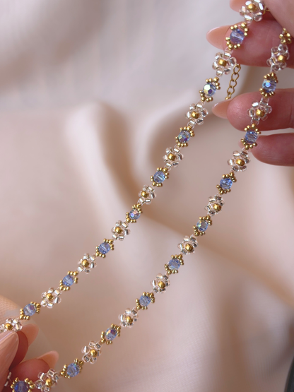 Close up of Wildflower Coquette Choker in Pixie Dust, showcasing premium Japanese seed bead daisies and blue Preciosa crystals.